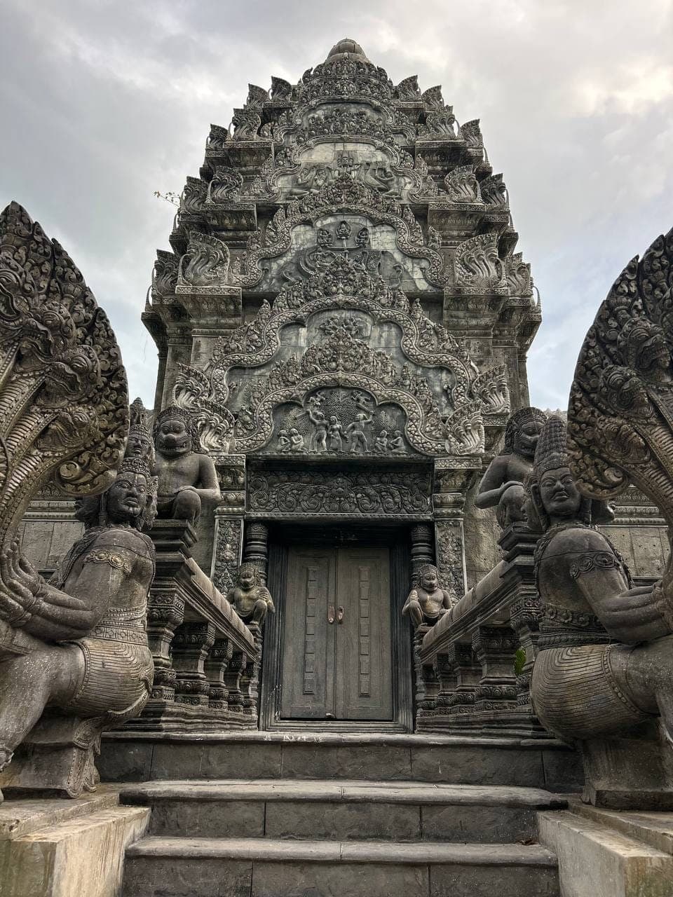 Carved temple entrance guarded by naga statues